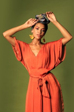 young woman wearing orange dress with turban ethnic jewelry